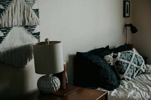 united states white table lamp on wooden side table bed